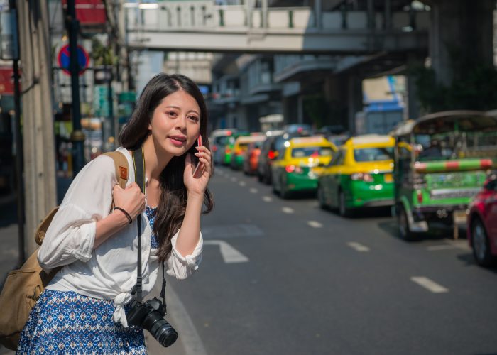 Female tourist waiting for taxi or rideshare