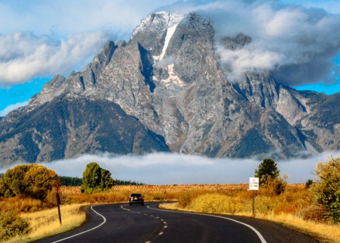 grand teton national park road with mountain background