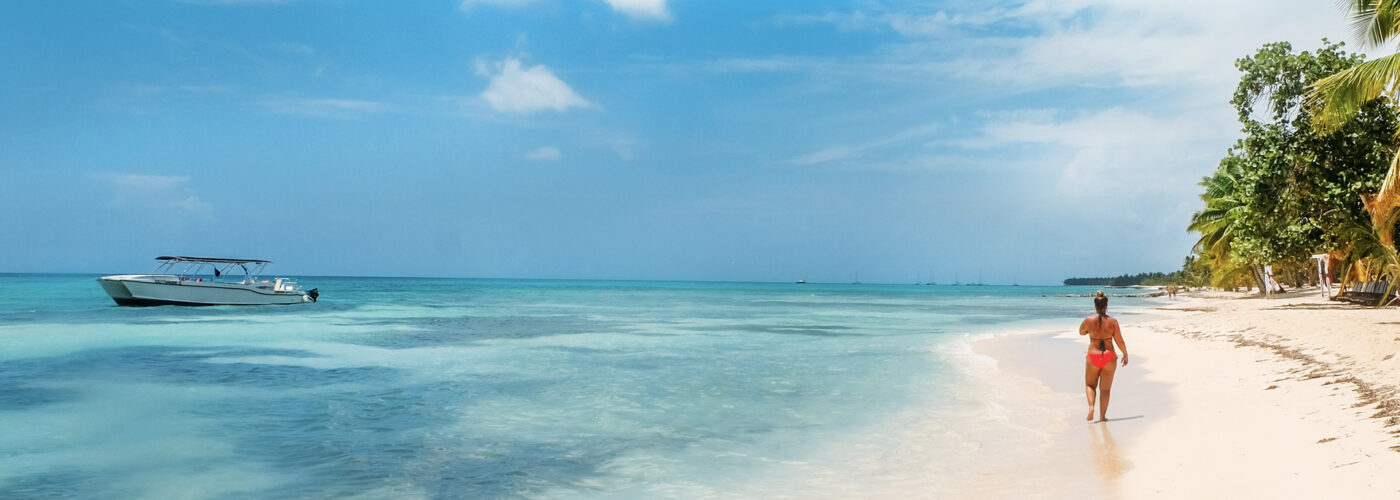 woman walking on caribbean beach.
