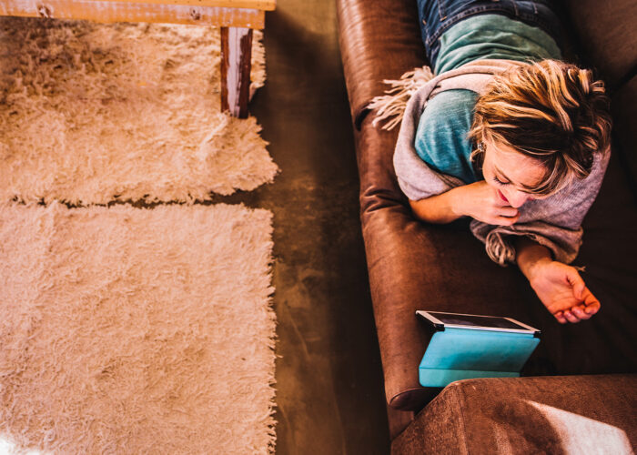 woman couch ipad lounging sofa bored