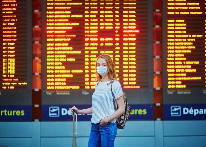 woman at airport wearing mask.