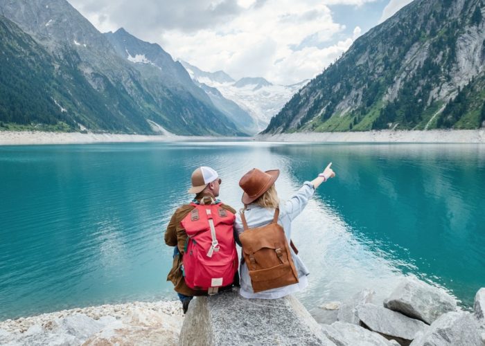 hikers pointing at lake.