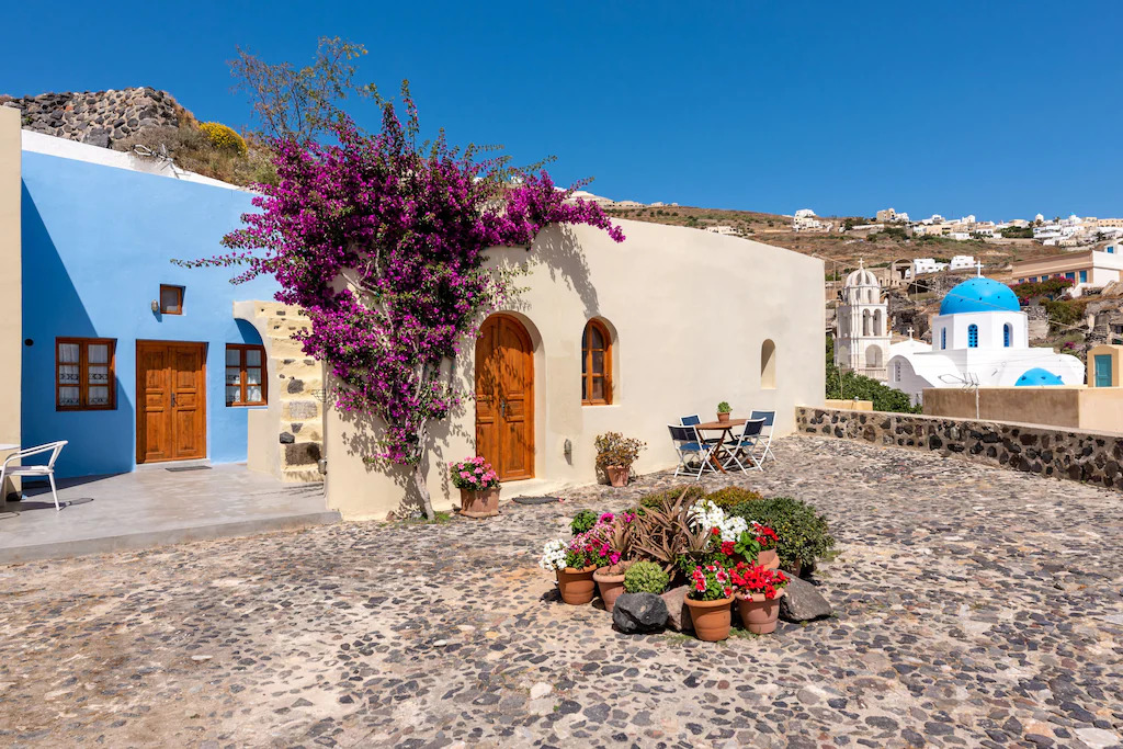The exterior of an old blue and white home in Santorini, Greece