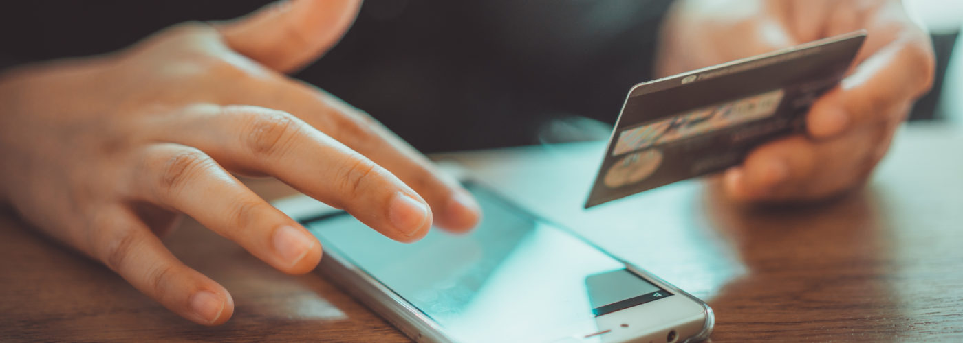 Person making a credit card purchase on smartphone