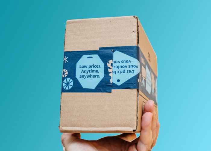 Person holding up an Amazon Prime package