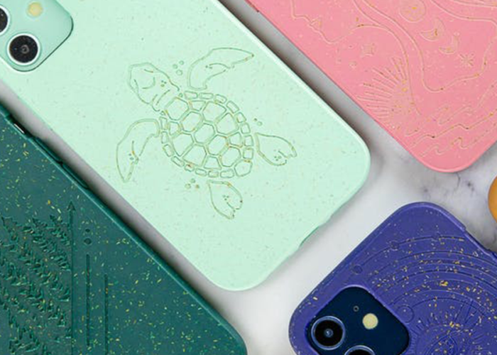 Several colors of Pela phone case on a white marble background