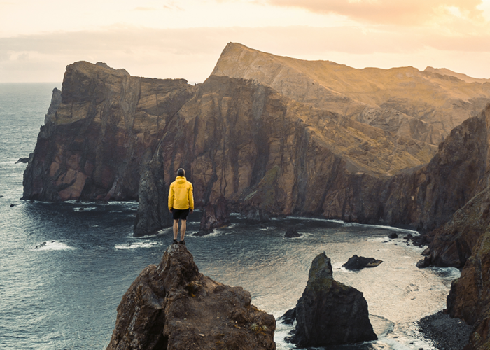 Hikers overlooking cliffs and ocean