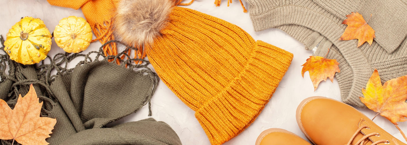 Flat lay with fall clothes, shoes, pumpkins, and leaves